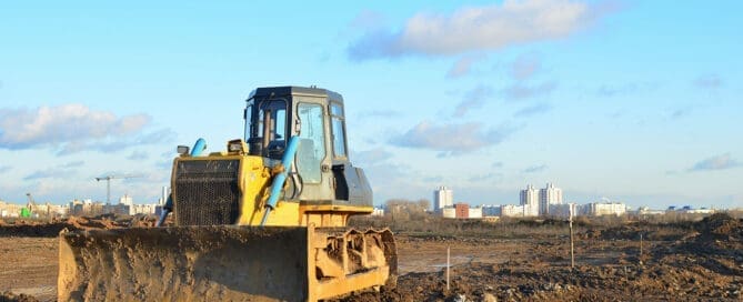 A green-certified construction site with heavy machinery preparing soil, symbolizing eco-friendly ground improvement for sustainable building projects.