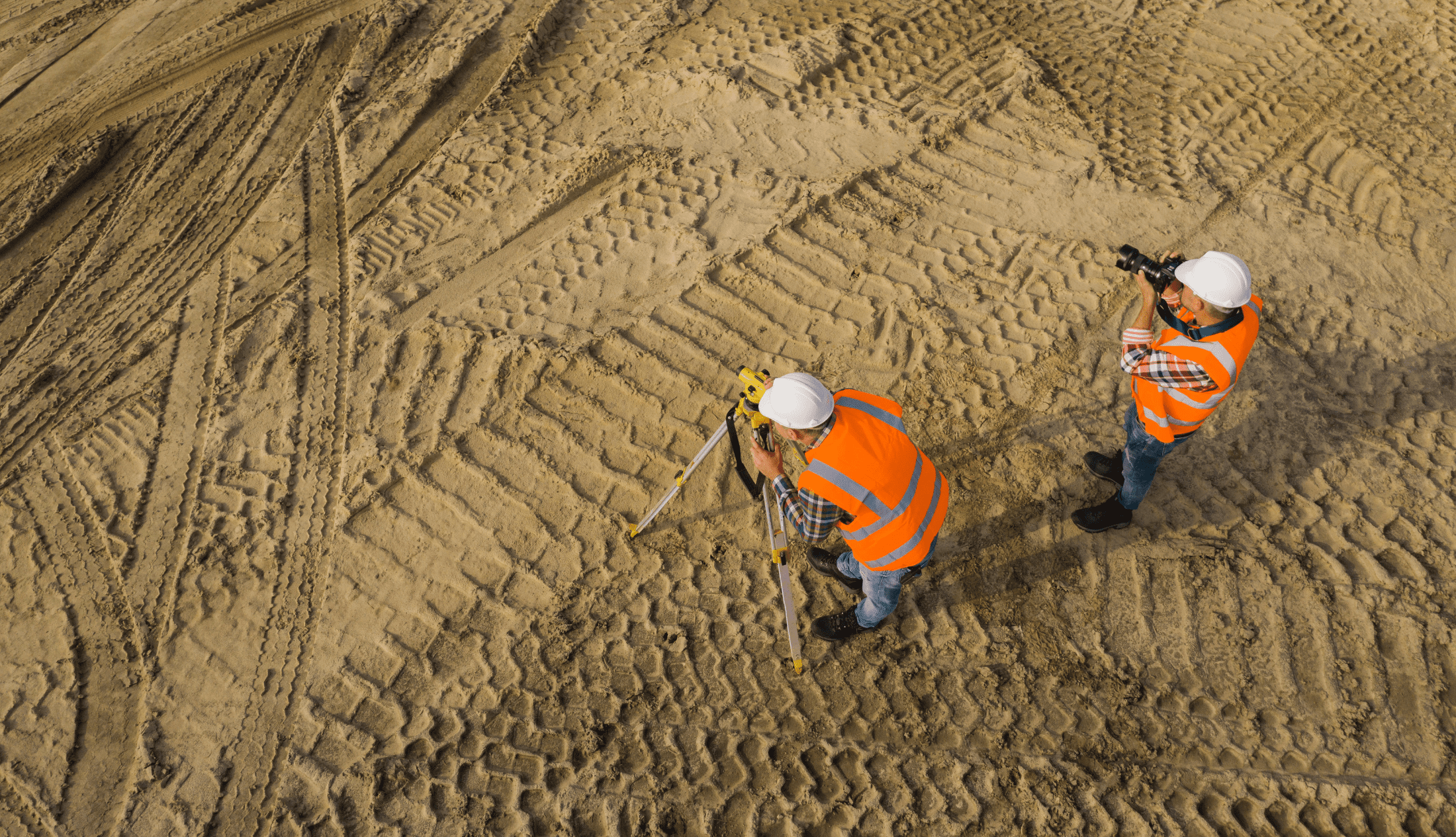 two Densification employees analyzing the ground for a project