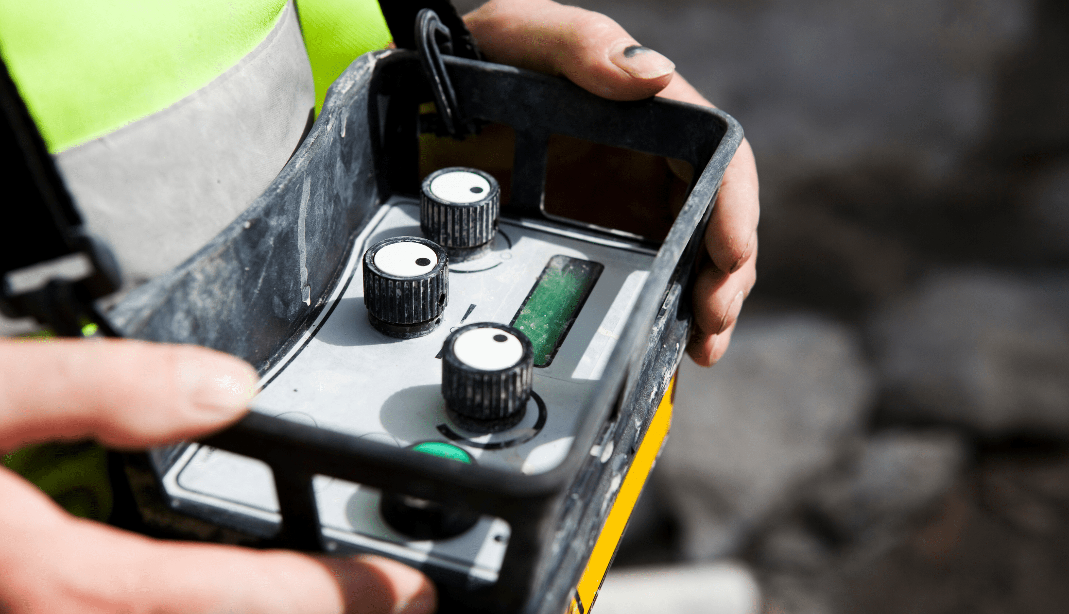 Cropped image of construction worker holding control panel